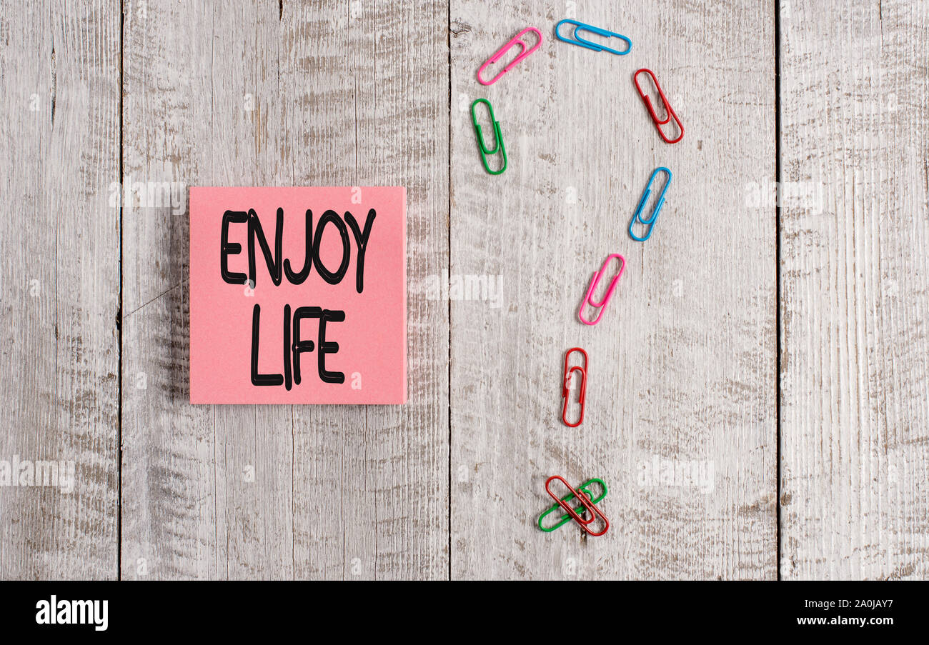Writing note showing Enjoy Life. Business concept for Any thing, place,food or demonstrating, that makes you relax and happy Pastel colour note paper Stock Photo