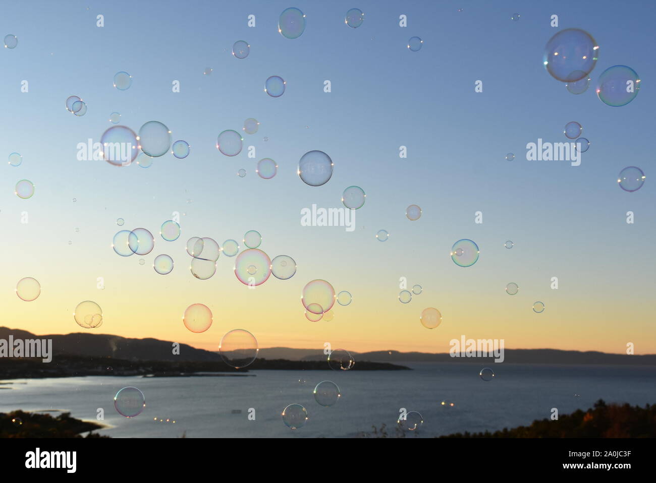 Sunset seascape with lot of soap bubbles Stock Photo