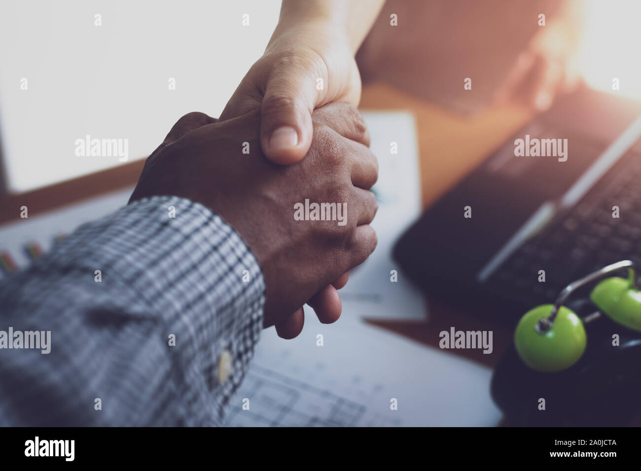 Two colleague shaking hands together celebrating finished work. Business concept. Stock Photo