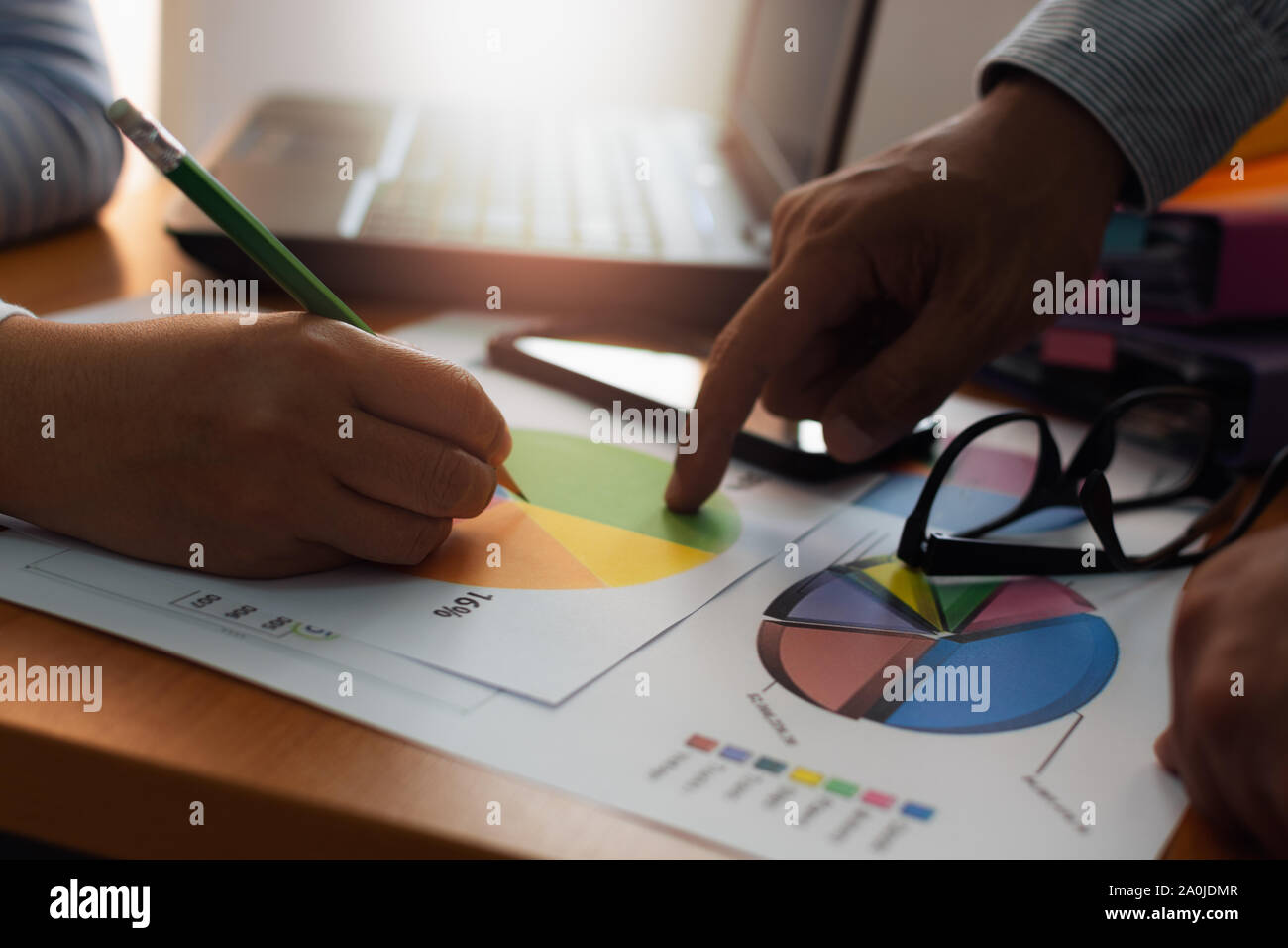 Two colleagues discussing and planing together with trade data chart document on office desk. Business and Office life concept. Stock Photo