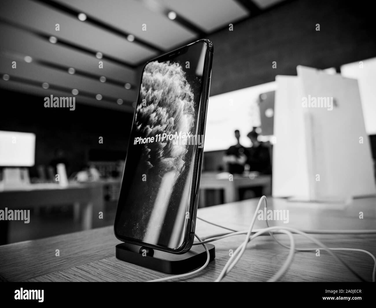 Paris, France - Sep 20, 2019: The new iPhone 11 Pro Max displayed in Apple Store as the smartphone by Apple Computers goes on sale - silhouettes of people in background demo screensaver black and white Stock Photo