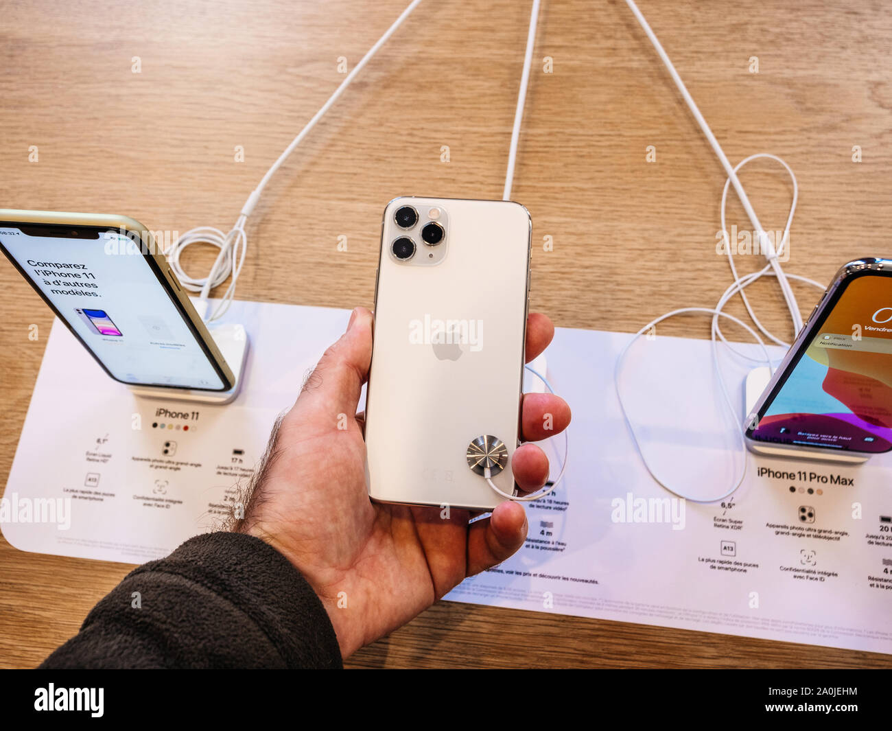 Paris France Sep 19 Man Hand Holding Looking At Triple Camera Of The New White Iphone 11 11 Pro And Pro Max Are Displayed In Apple Store As The Smartphone