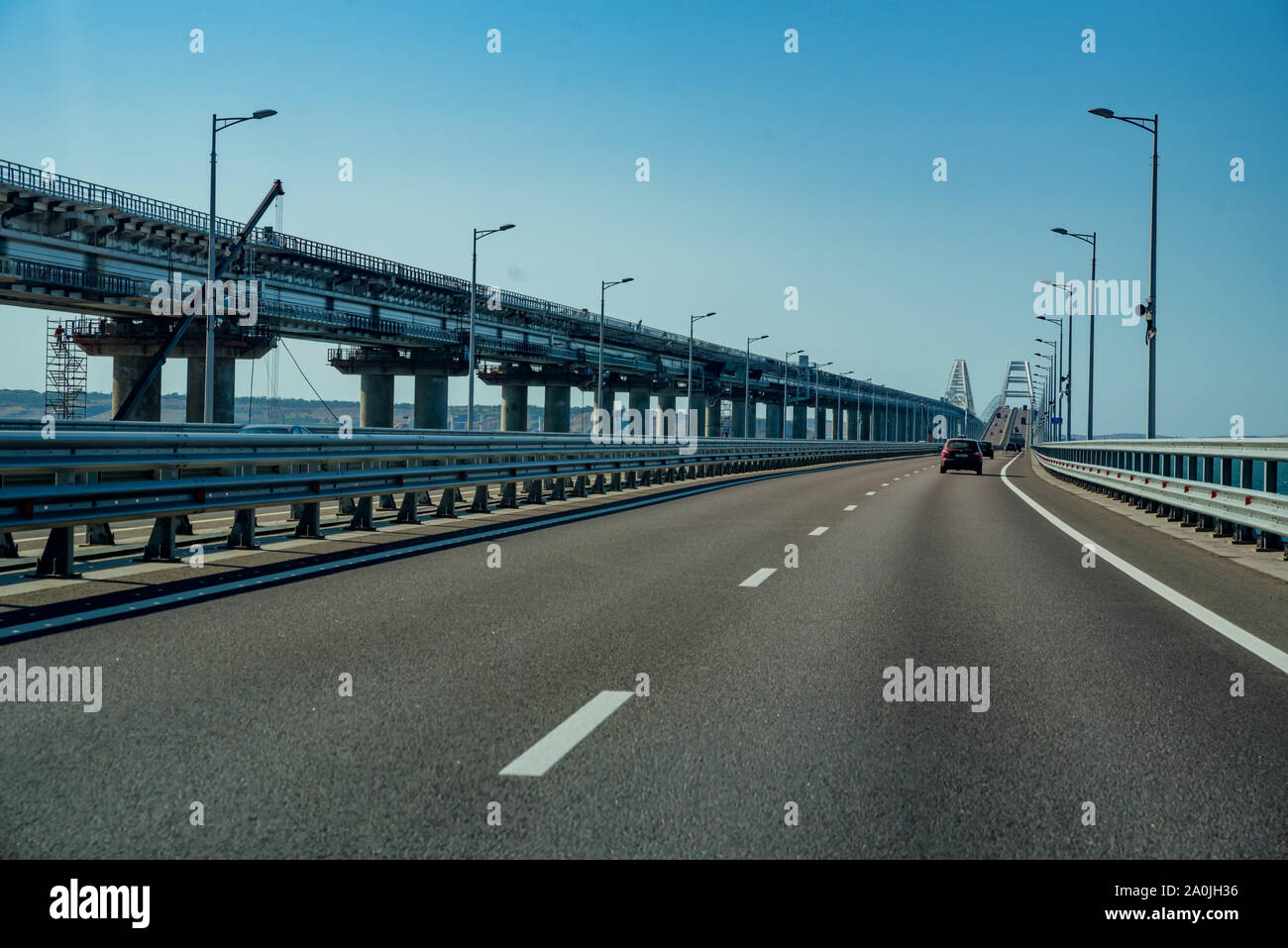 KERCH, RUSSIA - 5 AUGUST 2019: Cars go on the Crimean automobile bridge connecting the banks of the Kerch Strait: Taman and Kerch. Sunny summer day Stock Photo