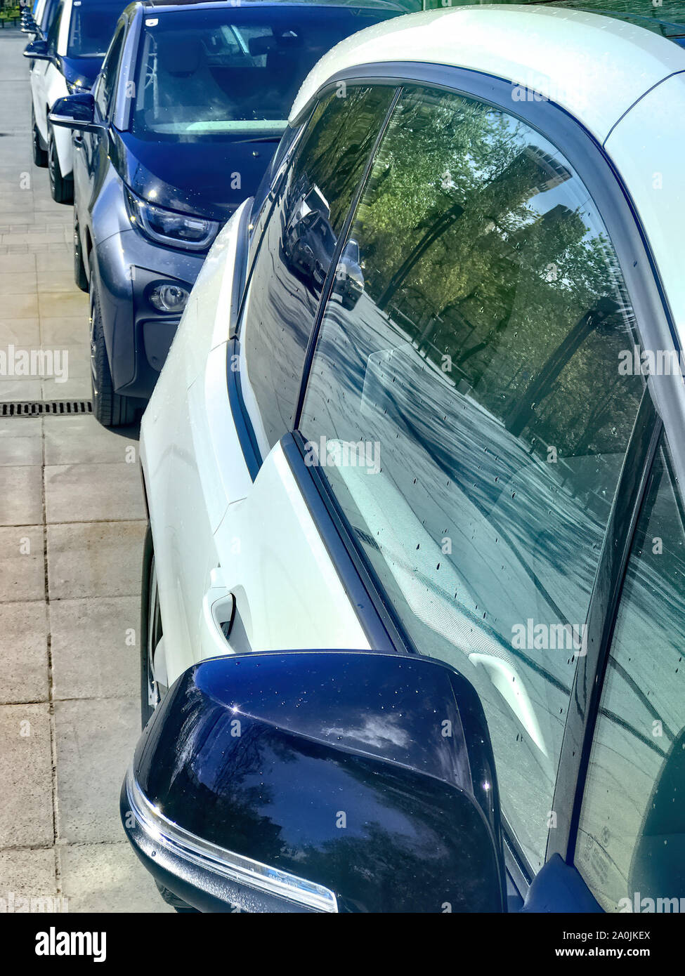 Electric vehicle being plugged in Stock Photo - Alamy