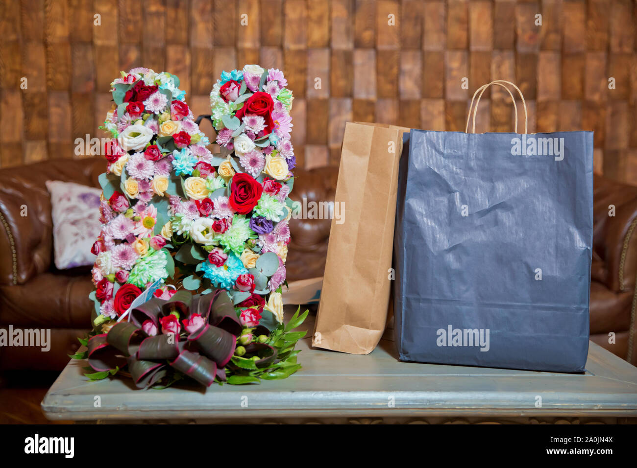 colorful flower bouquet in paper gift bag Stock Photo - Alamy