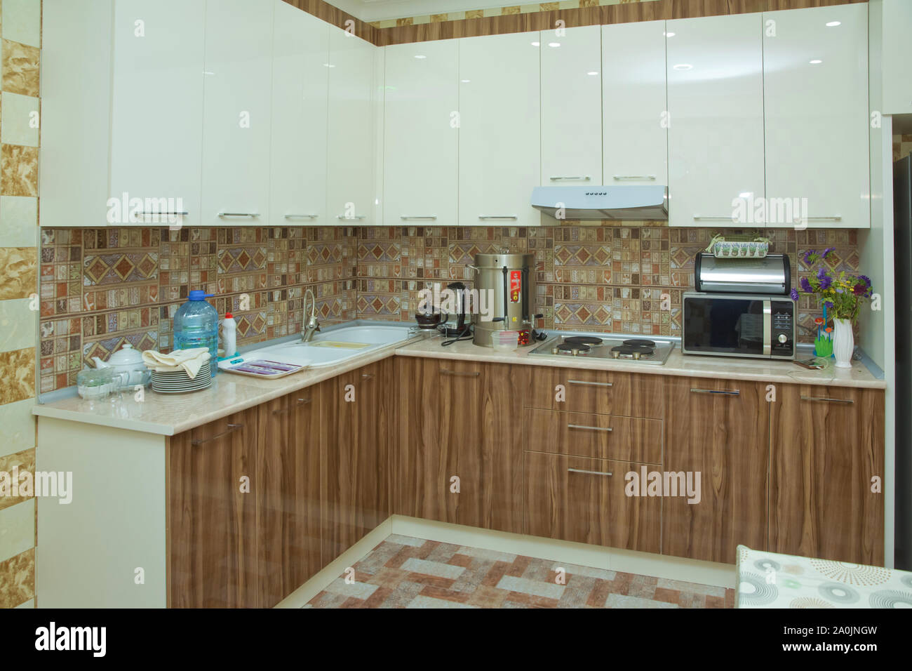 Brown and white Kitchen design, refrigerator . Modern kitchen with brown  kitchen cabinets, oversized kitchen . Stylish interior with dining Stock  Photo - Alamy