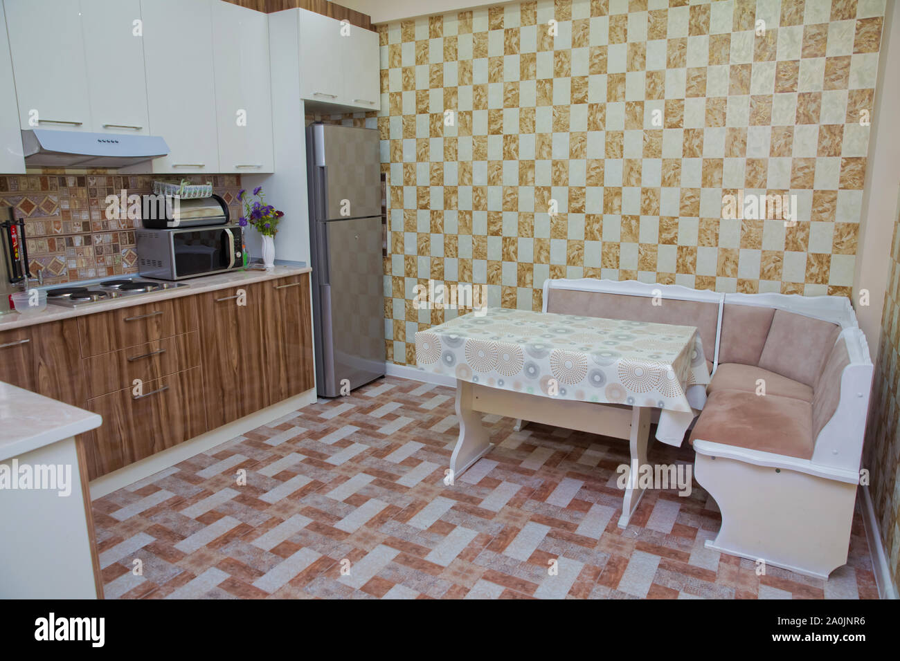 Kitchen corner sofa and table in the interior . design of orange white