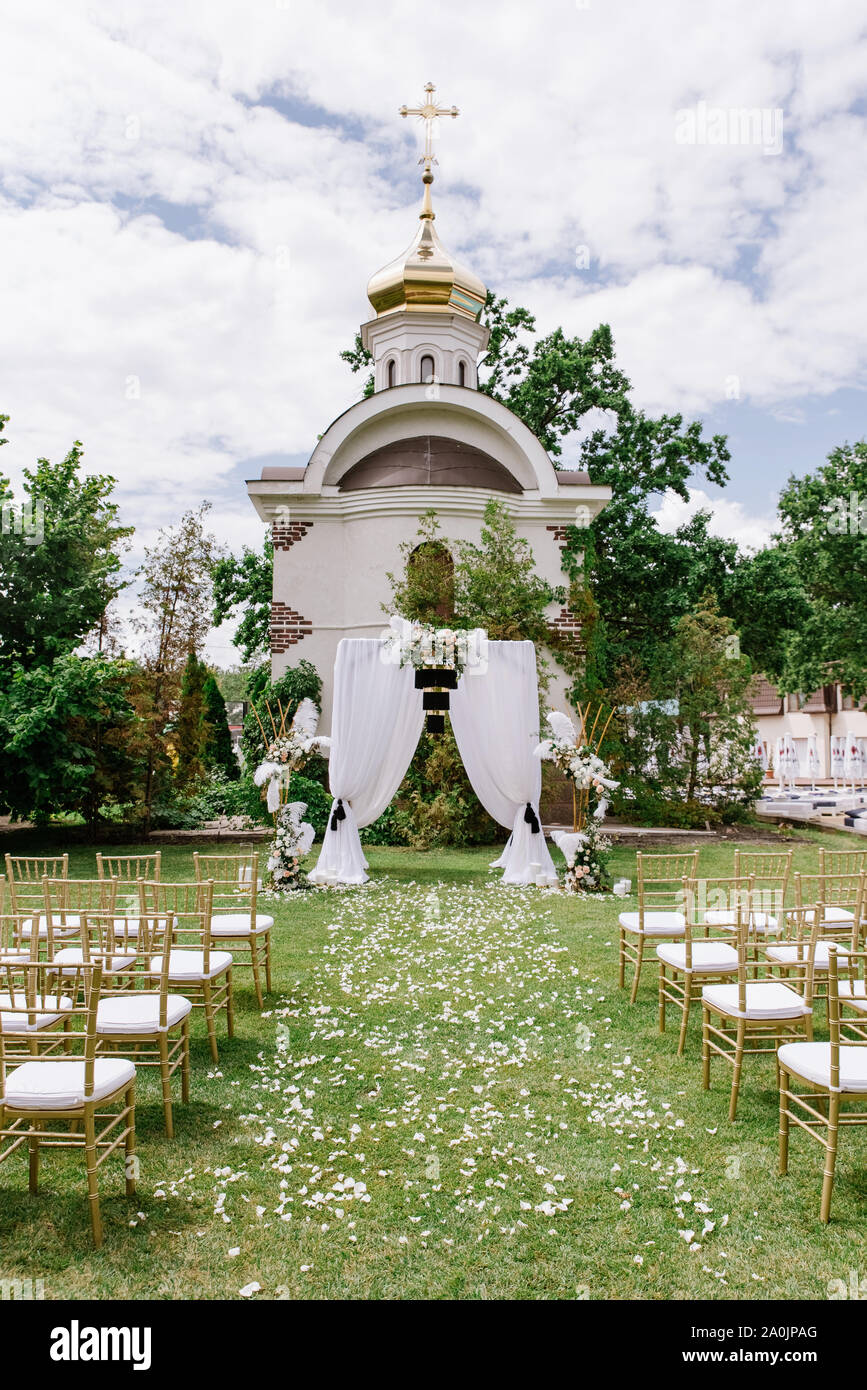 Open-air wedding ceremony against the background of the Orthodox Church in  summer on the lawn Stock Photo - Alamy