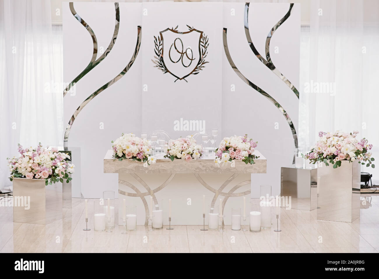 Luxurious wedding presidium in white with silver elements. Groom and bride  's table a stylish white background Stock Photo - Alamy