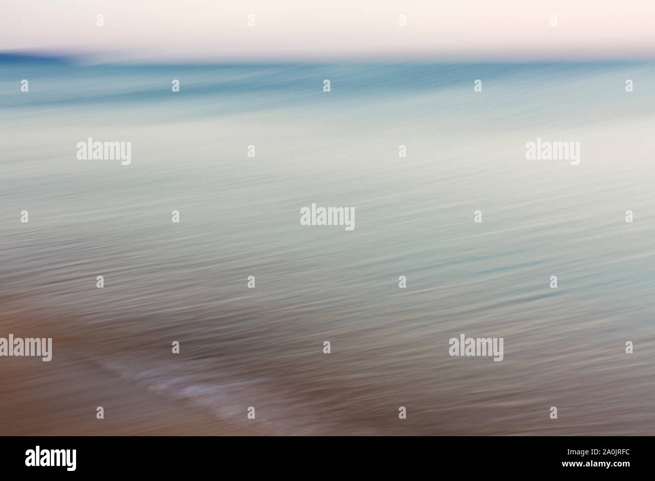 Waves on beach at sunset hi-res stock photography and images - Alamy