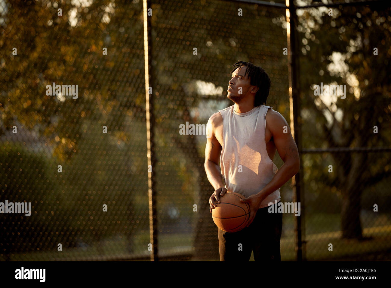 African-American man playing basketball outdoors Stock Photo