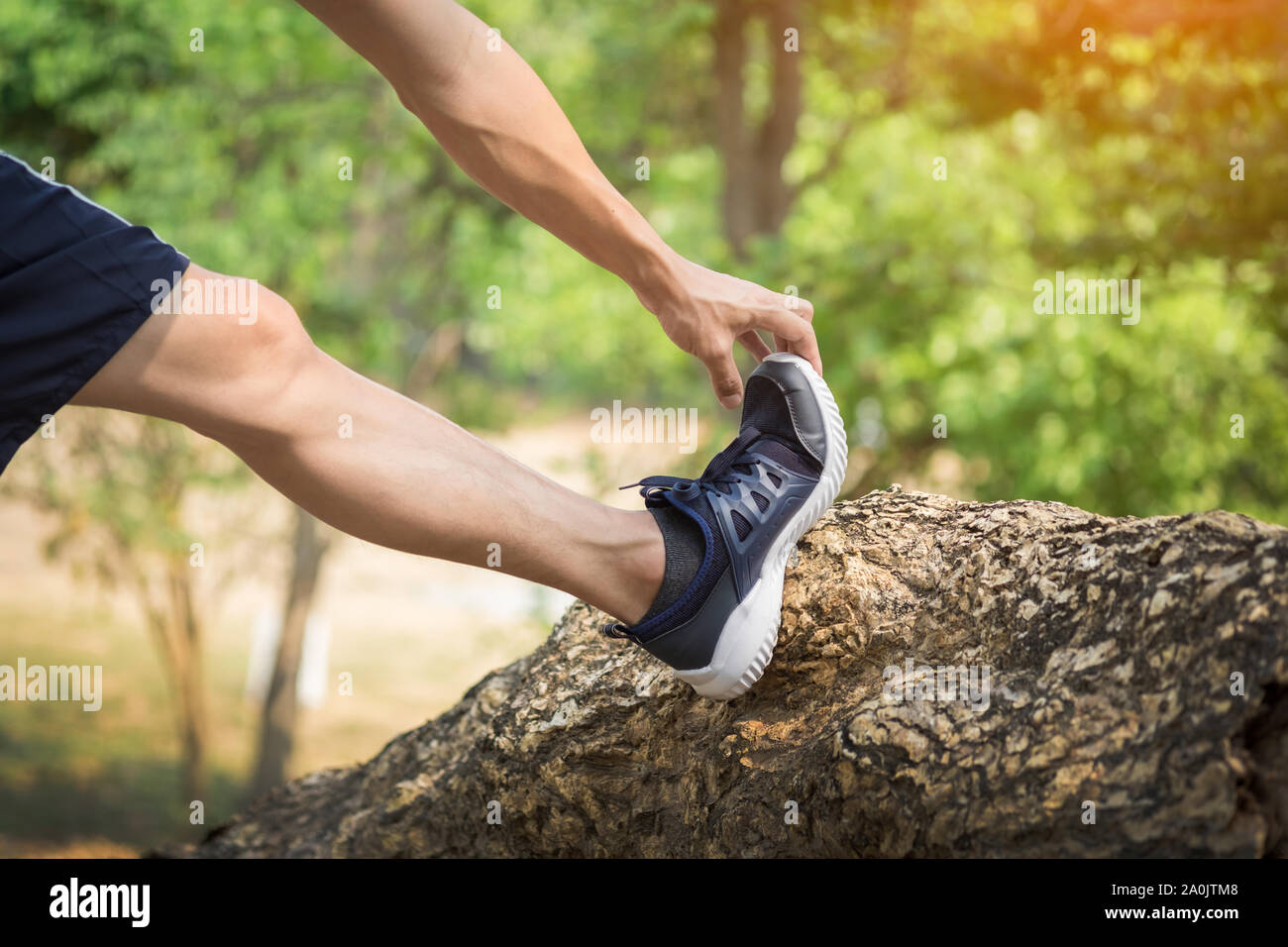 man stretching leg as warmup before run Stock Photo Alamy