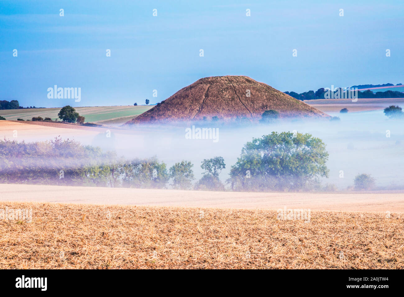 A late summer sunrise over Silbury Hill in Wiltshire. Stock Photo
