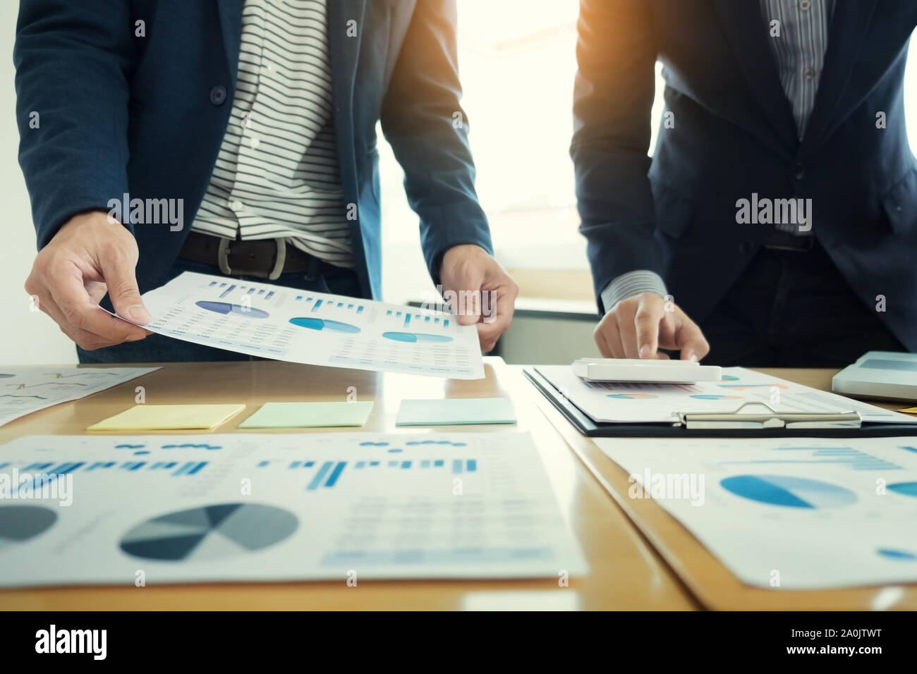 Team work process. young business managers crew working with new startup project. laptop on wood table, typing keyboard, texting message, analyze grap Stock Photo