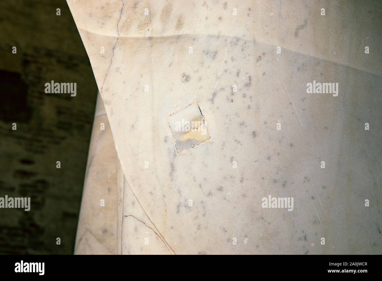 Marble patch close up. Detail in a medieval marble statue. Repair