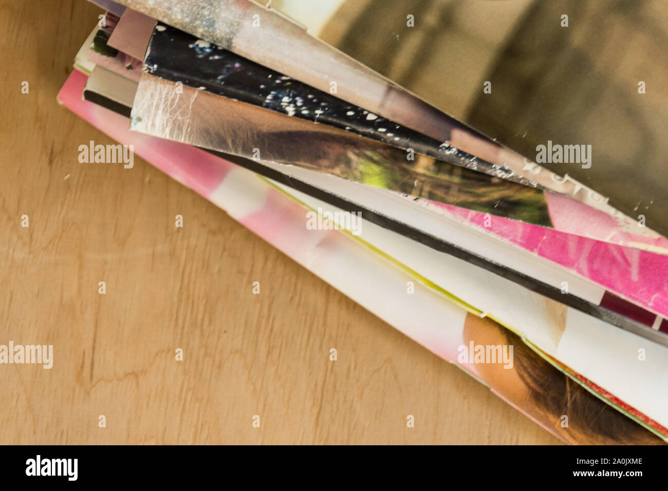 Stack of colorful magazines on the office wooden table. Copy space ...