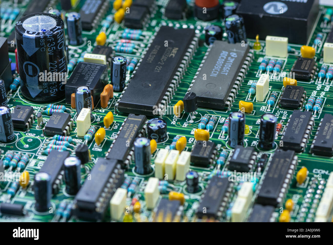 Close up shot of PCB unit with visible resistors, capacitors and micro procesors. Stock Photo