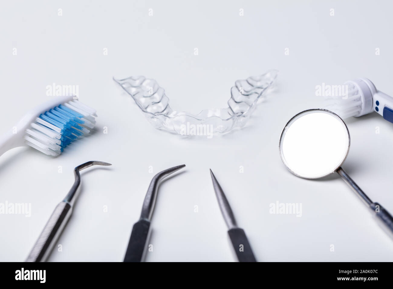 Dental Instruments And Clear Aligner On White Background Stock Photo