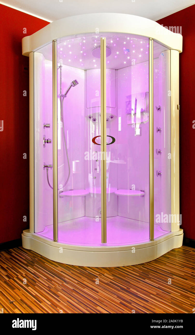 Big shower cabin in bathroom corner with pink light Stock Photo