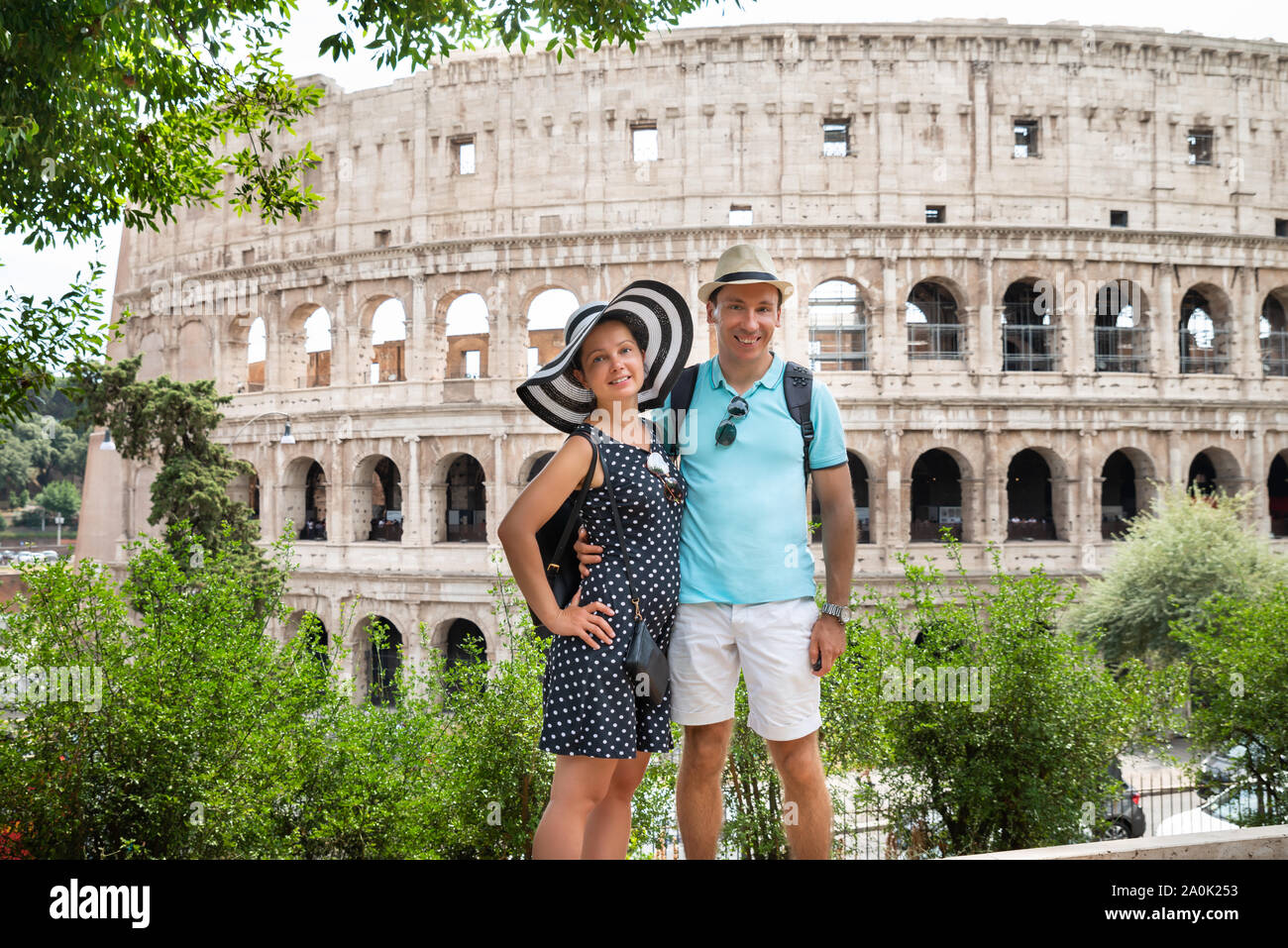 Young Tourist Couple Standing In Front Of Colosseum In Rome, Italy Stock Photo