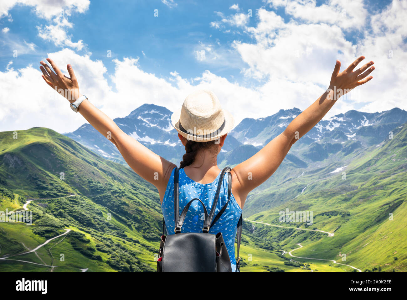 Woman With Backpack Enjoying Panoramic Mountain View Stock Photo