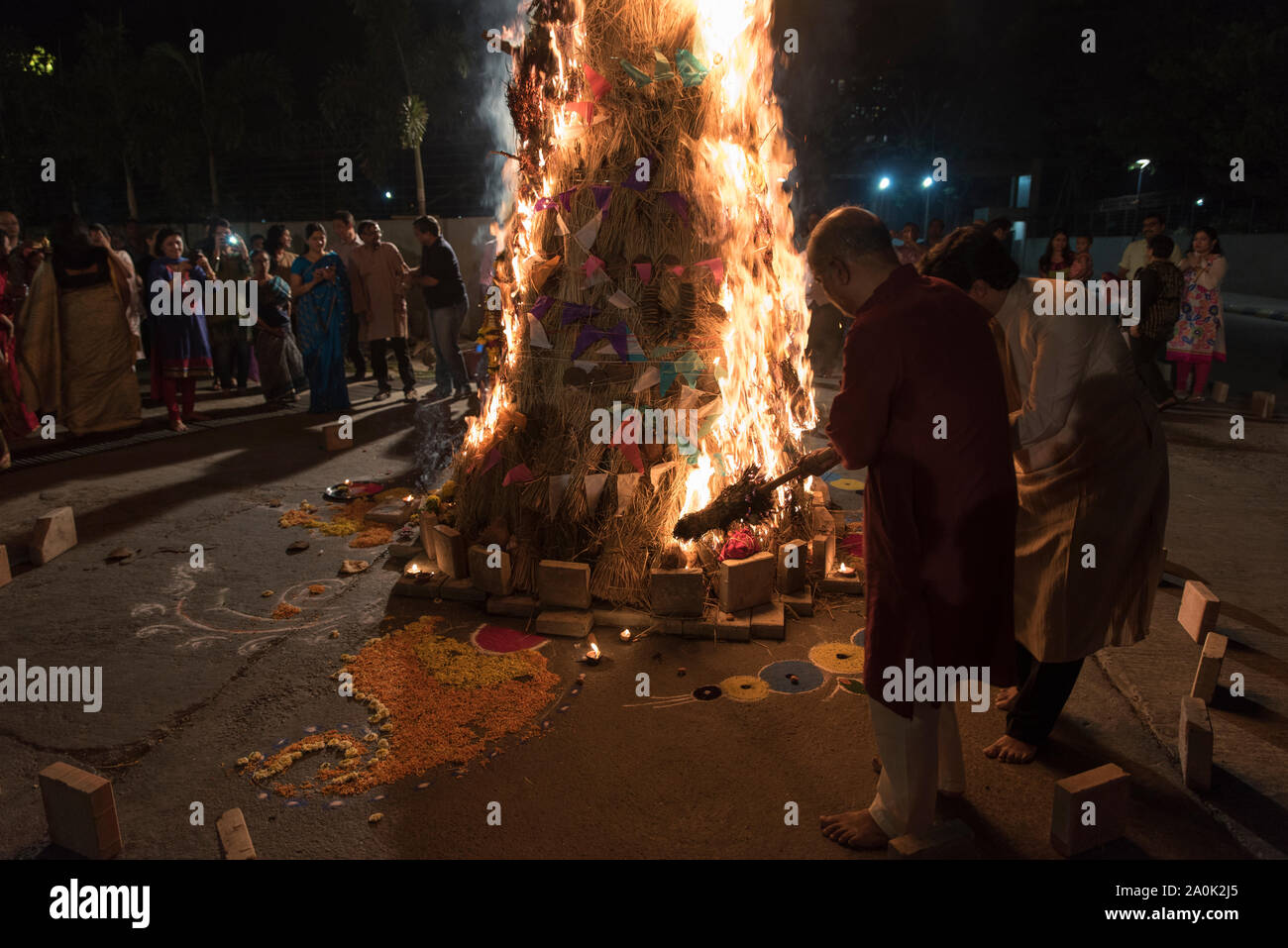 Holi bonfire is set alight at a housing complex in Mumbai, India. This festival is celebrated with friends with a splash of coloured powder and water. Stock Photo