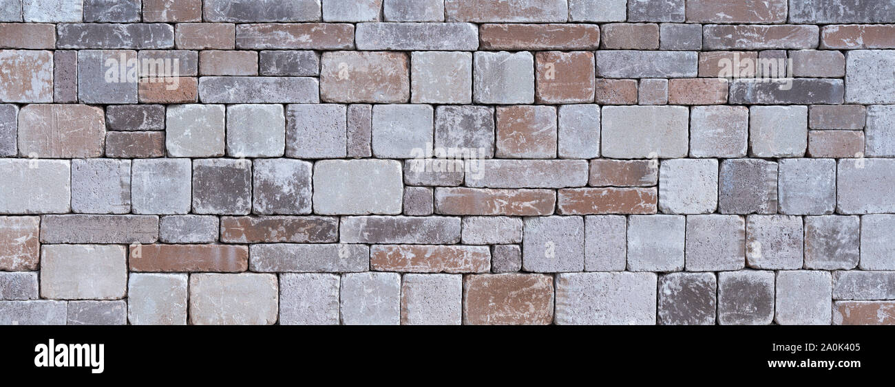 Stone wall made of different square natural stones Stock Photo