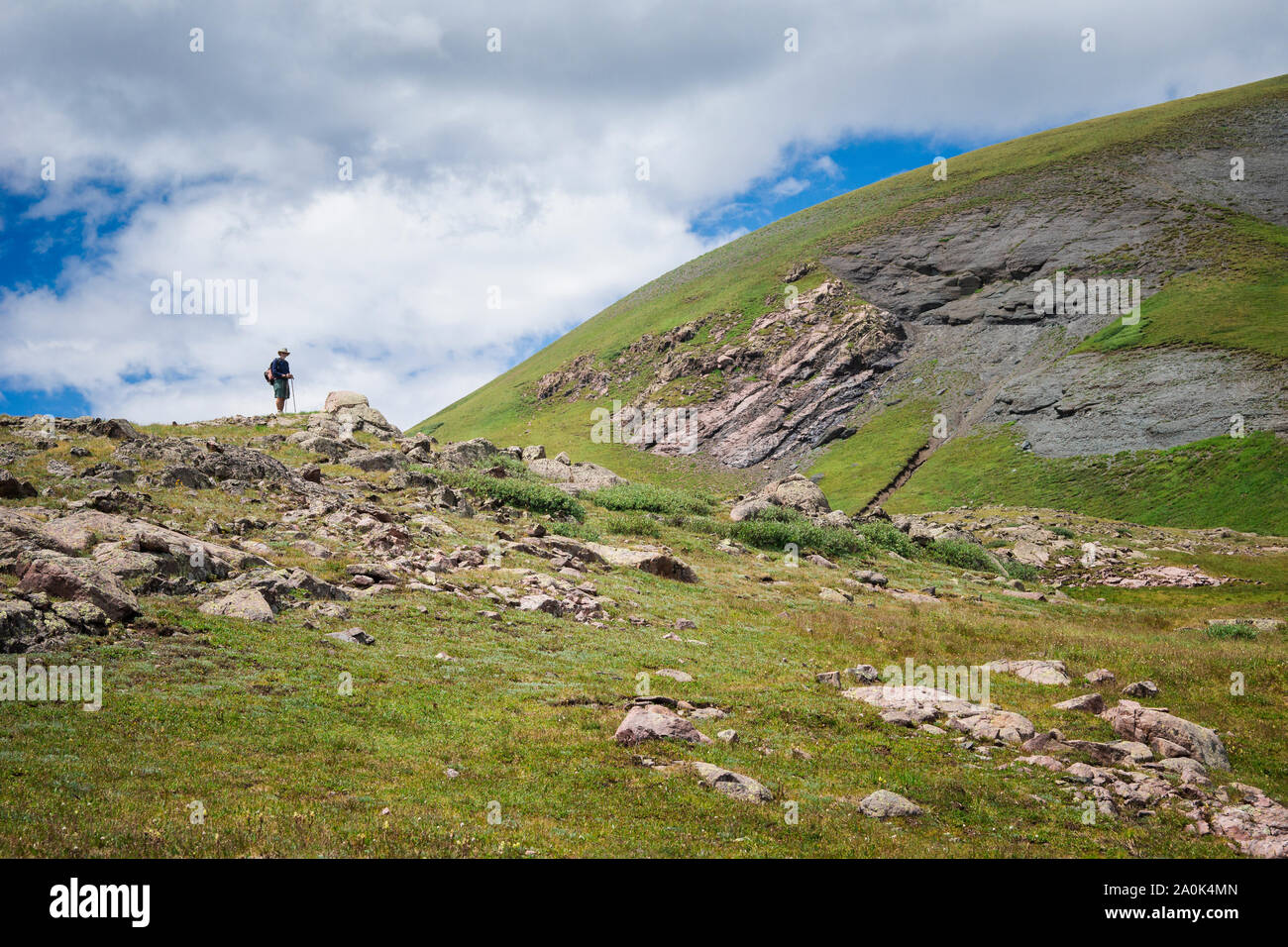 Lone hiker on a ridge above tree line in the San Juan Mountains, Weminuche Wilderness, Rocky Mountains, Colorado, USA Stock Photo