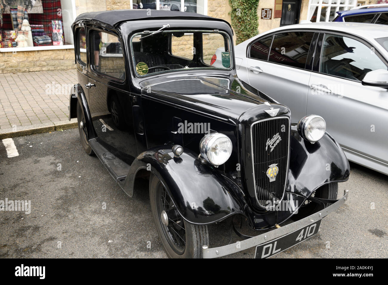 Black 1937 Austin Seven Ascot classic car parked on High street Bourton-on-the-Water Cotswold District England Stock Photo