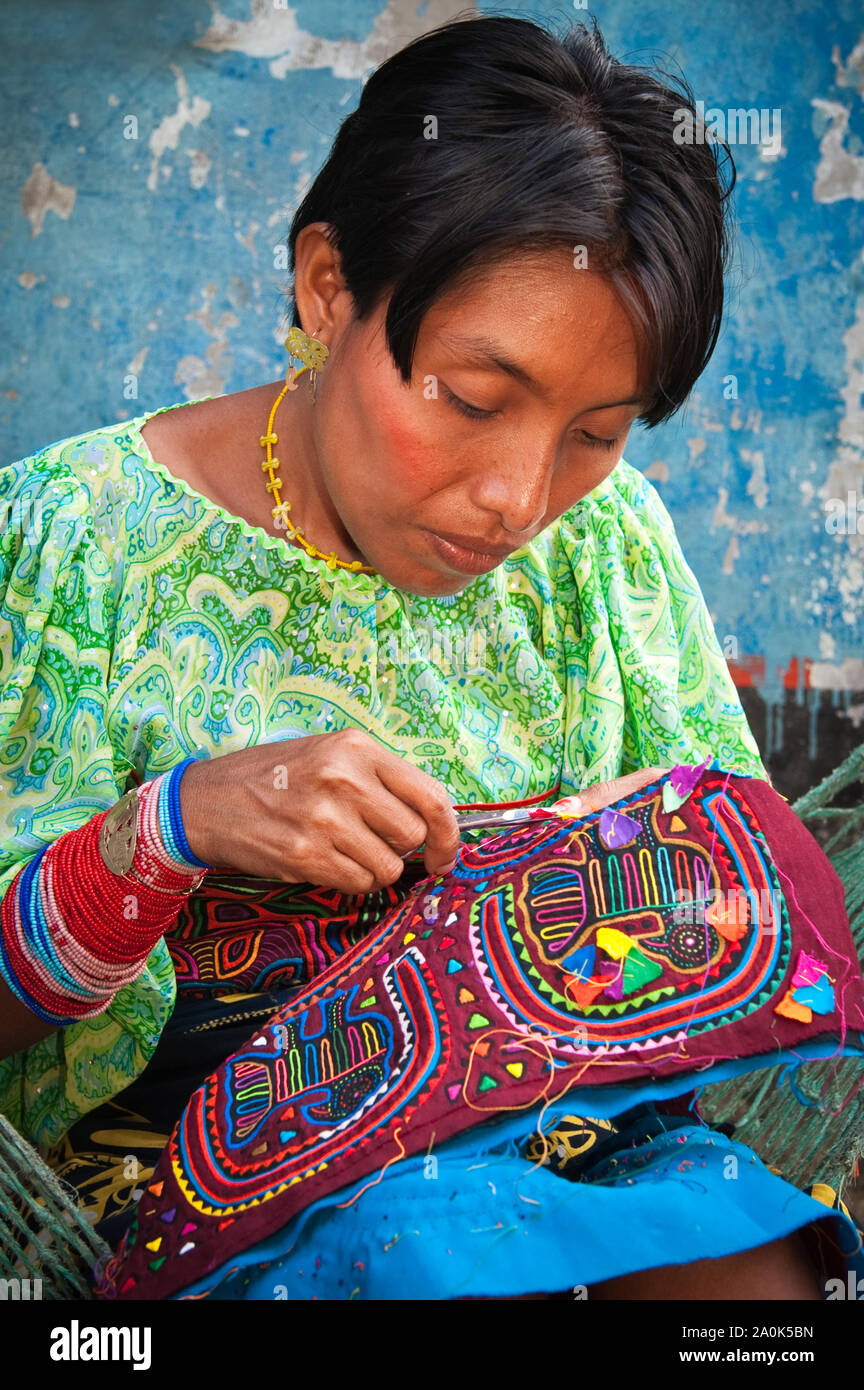 Kuna Indian woman wearing a traditional mola blouse, sews and embroiders a  handcrafted mola, Kuna (Guna)Yala/San Blas Islands, Caribbean coast, Panama  Stock Photo - Alamy