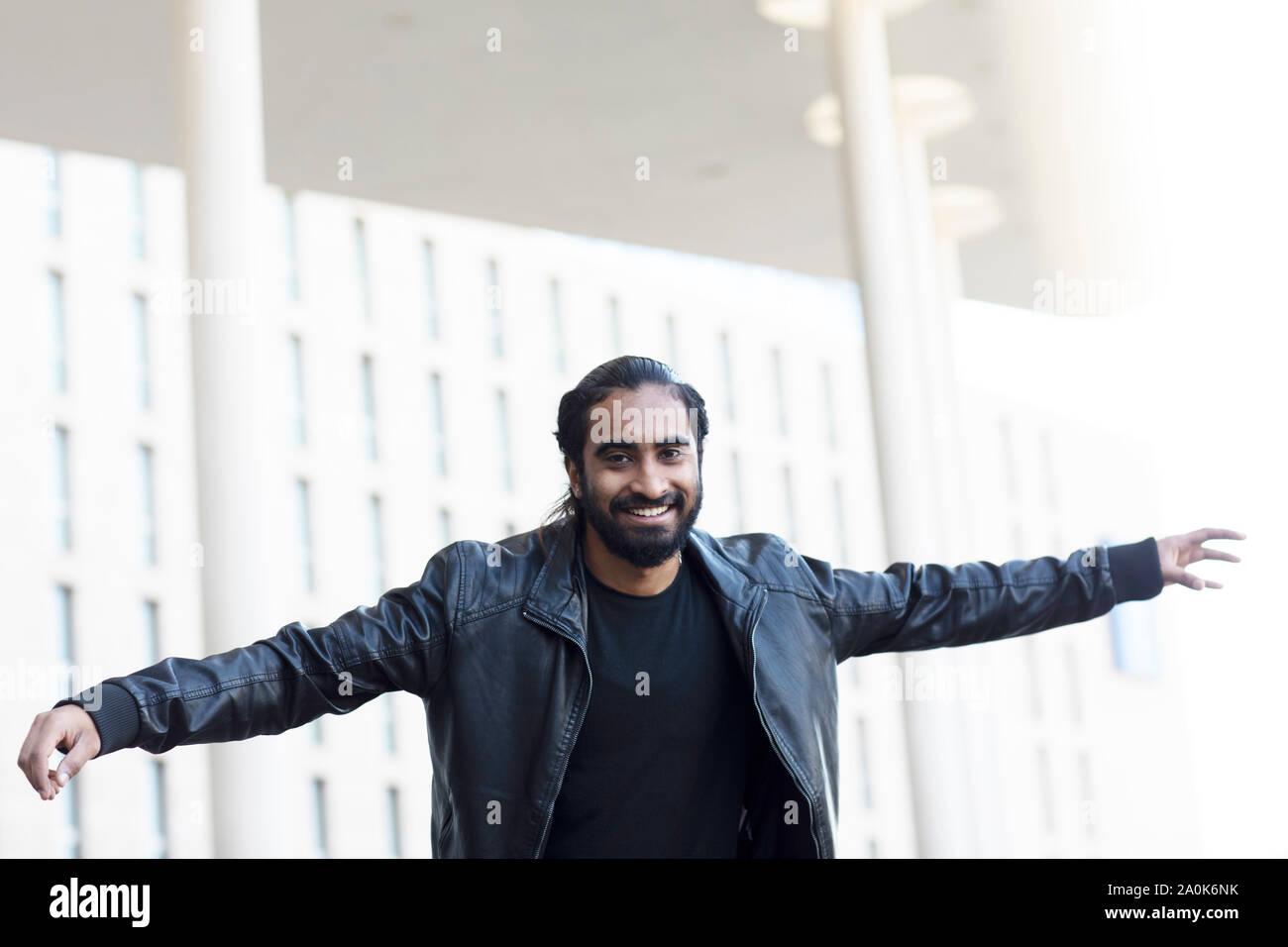 young man spreading arms outside Stock Photo - Alamy