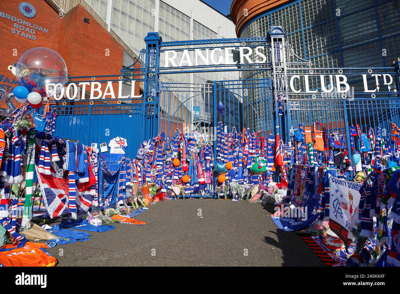 Glasgow, UK. 20th Sep, 2019. Tributes including flowers, scarves, football  tops, cards and cakes have been left at the Broomloan Road and Copland Road  gates of Ibrox Football Stadium, the home of