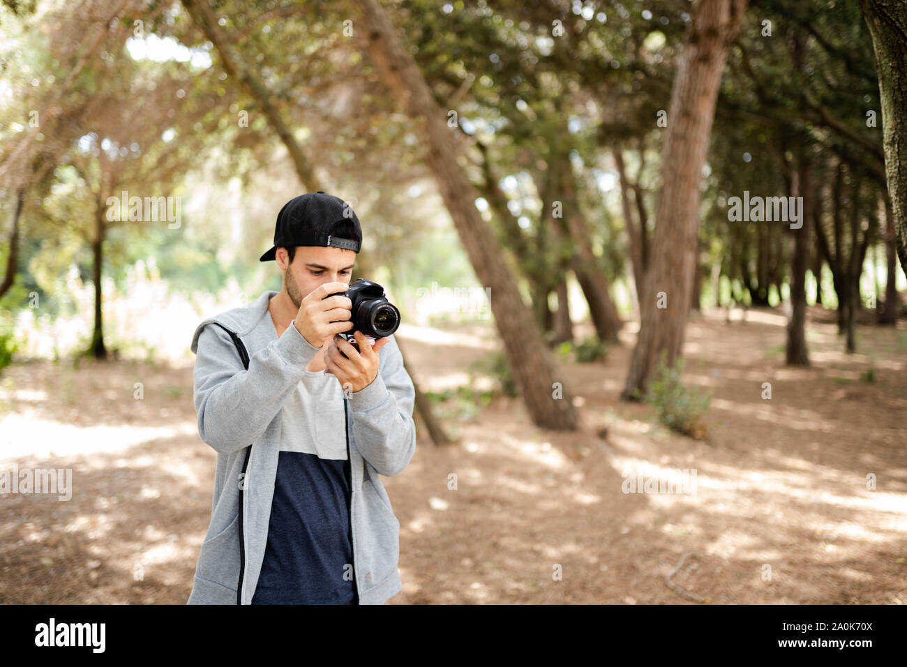 man working as a photographer shooting pictures and video editing Stock Photo