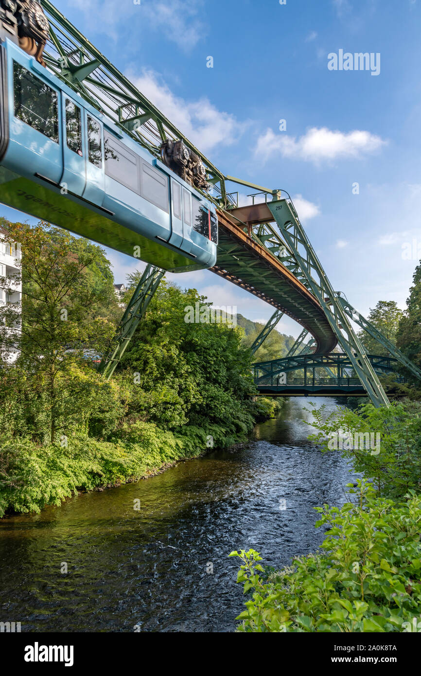 The amazing hanging monorail called the Schwebebahn in Wuppertal, near Dusseldorf in Western Germany. All trains are now this pale blue colour. Stock Photo