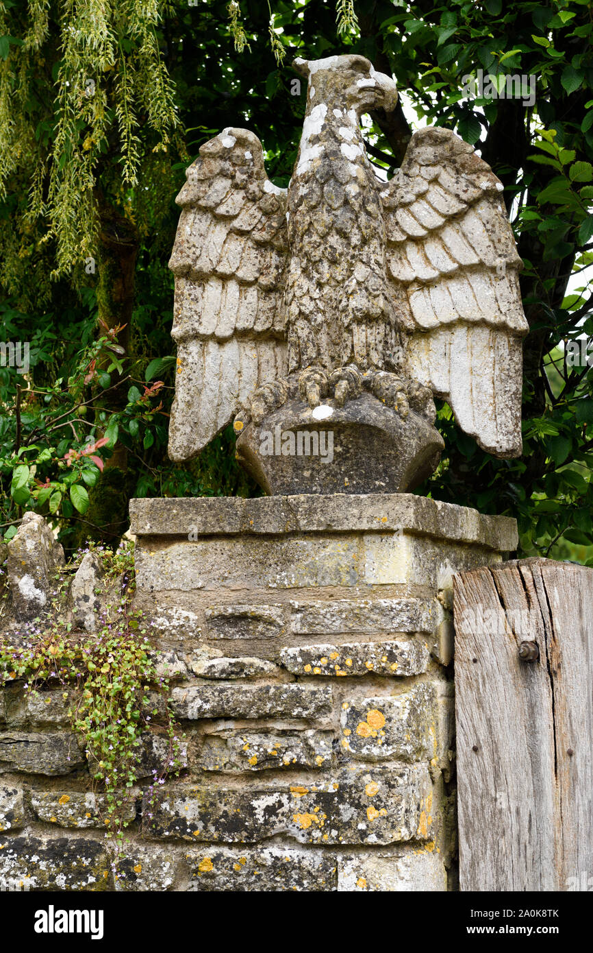 Stone eagle statuette on gate post near St Mary church Bibury Gloucestershire England Stock Photo