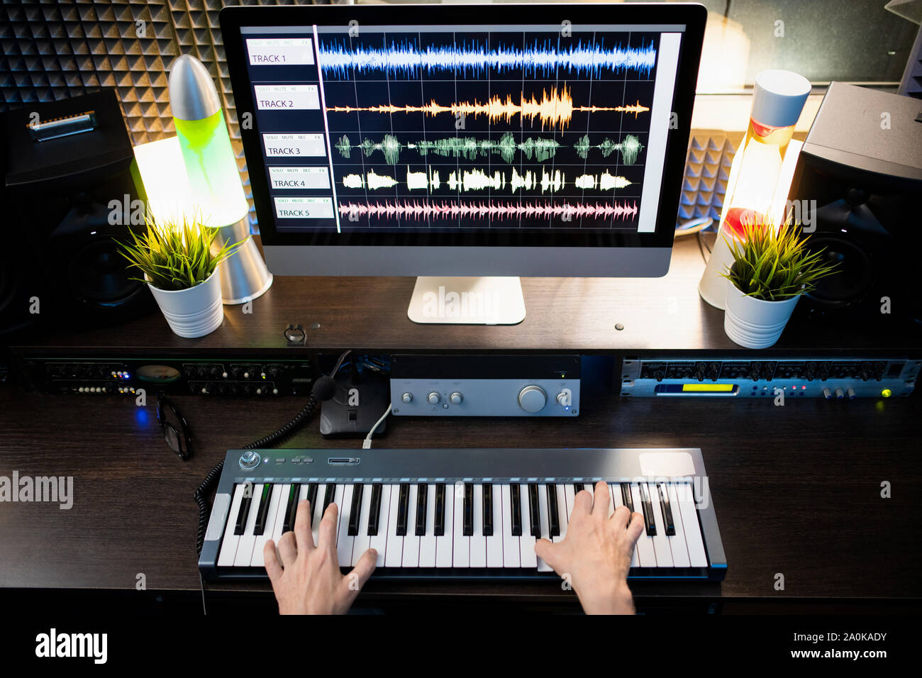 Music studio full of instruments and pc display Stock Photo - Alamy