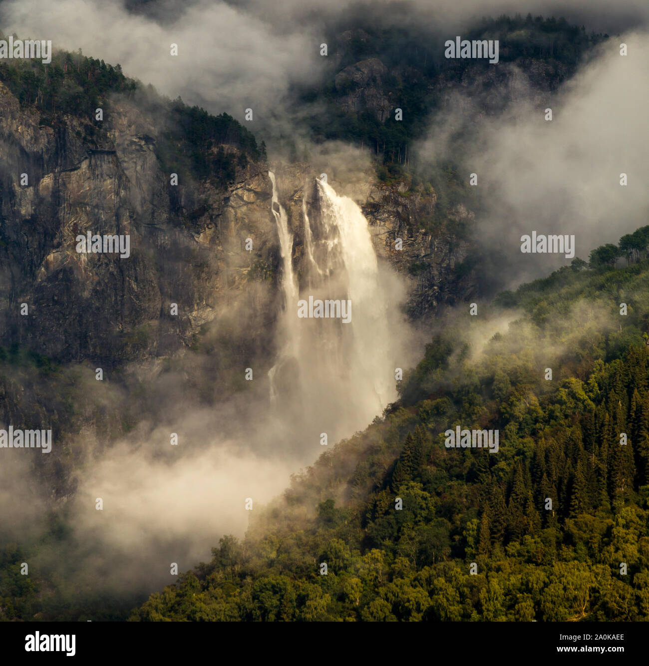 Feigumfossen with mist and clouds Stock Photo