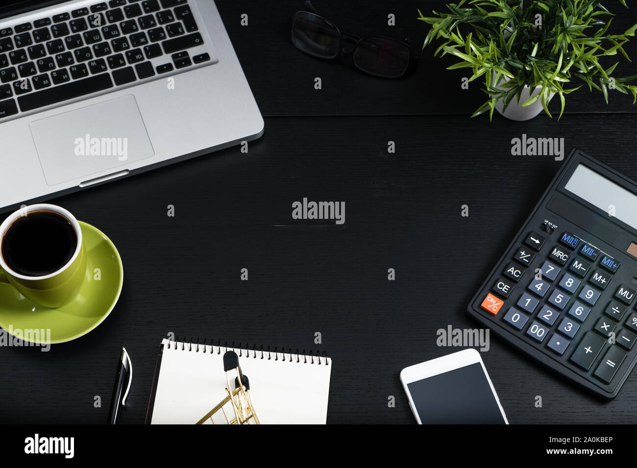 Gold cart, cash and gadgets on a black table. Stock Photo