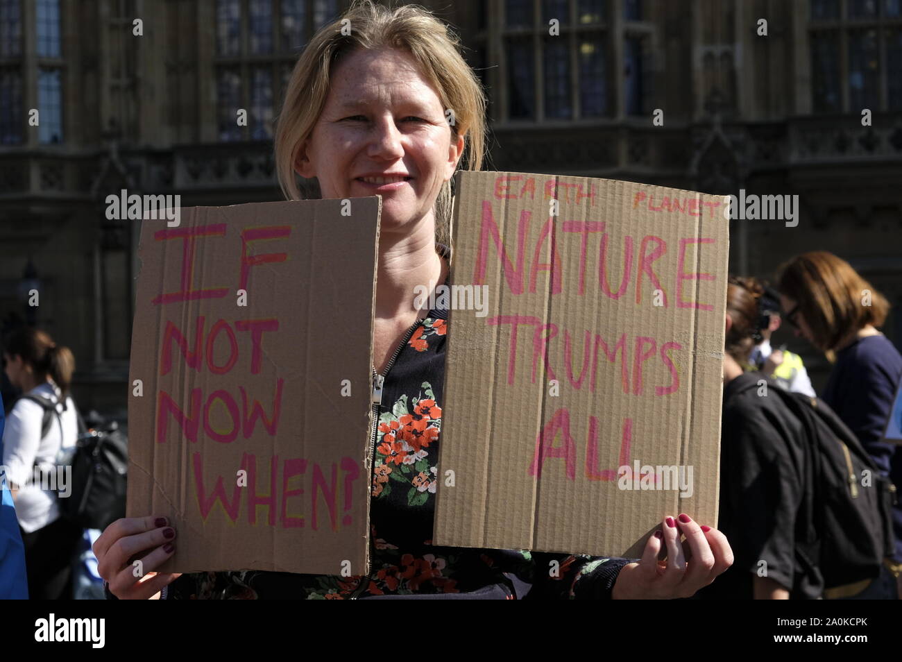 A protester holds placards during the demonstration.Adult and youth walking out of work and schools to demand for an end to the use of fossil fuels and demanding urgent action on climate change to save the planet. Stock Photo