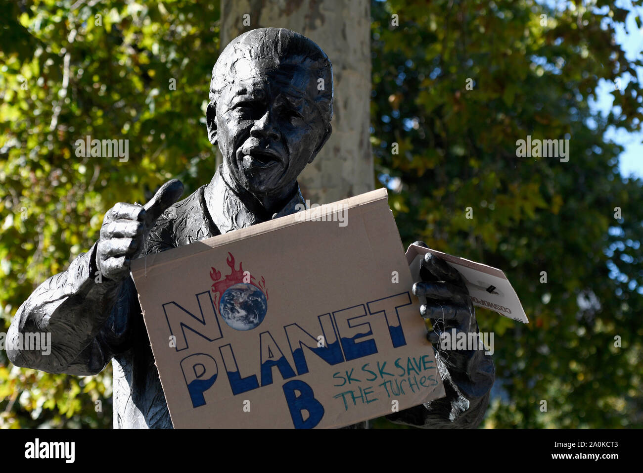 A placard that says no planet b hangs on the Mandela's sculpture during the protest in London.Adult and youth walking out of work and schools to demand for an end to the use of fossil fuels and demanding urgent action on climate change to save the planet. Stock Photo