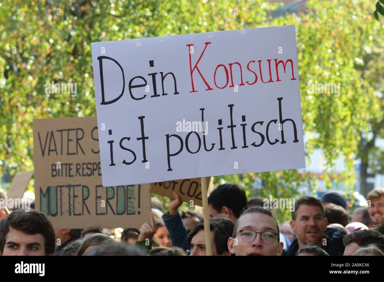 Demonstration during Global Climate Strike with sign saying 'Your consumption is political' in German Stock Photo
