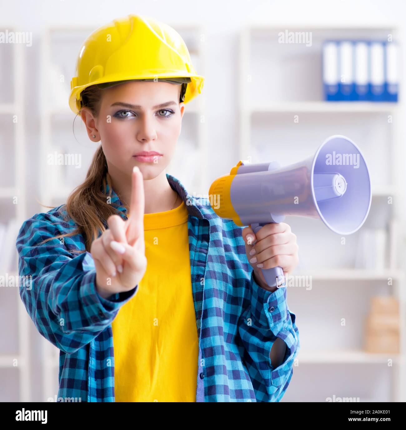 The angry building supervisor with megaphone Stock Photo - Alamy
