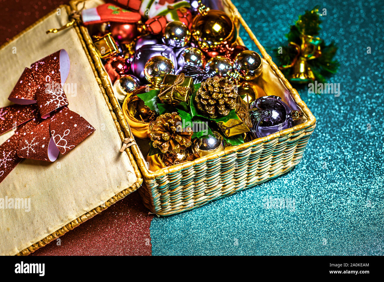 wicker box on a shiny floor full of Christmas decorations Stock Photo