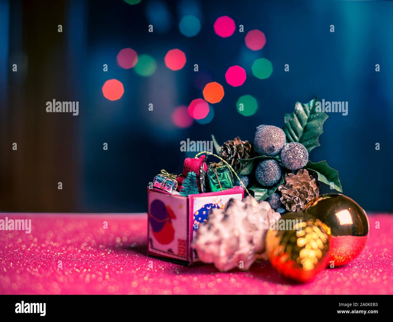 Christmas card with Christmas decorations and multicolor lights on blue background Stock Photo