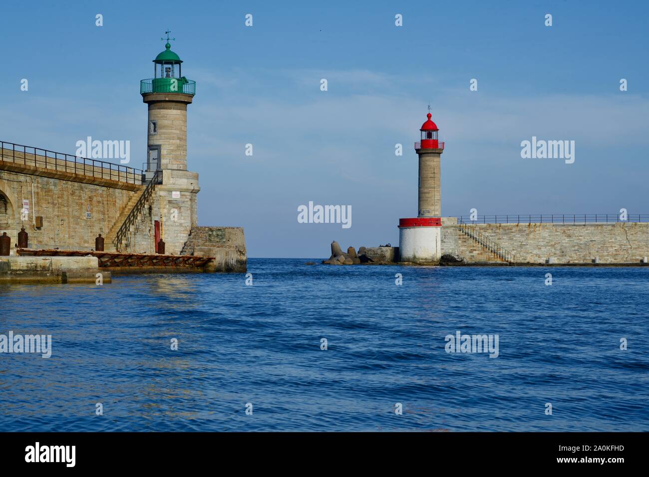Close-up of a green and a red lighthous at a harbour gateway Stock Photo