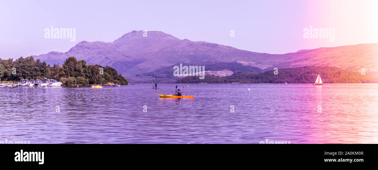 Luss at Loch Lomond, Scotland, 25 August 2019. People relaxing and having fun during one of the hot days in Summer. Stock Photo