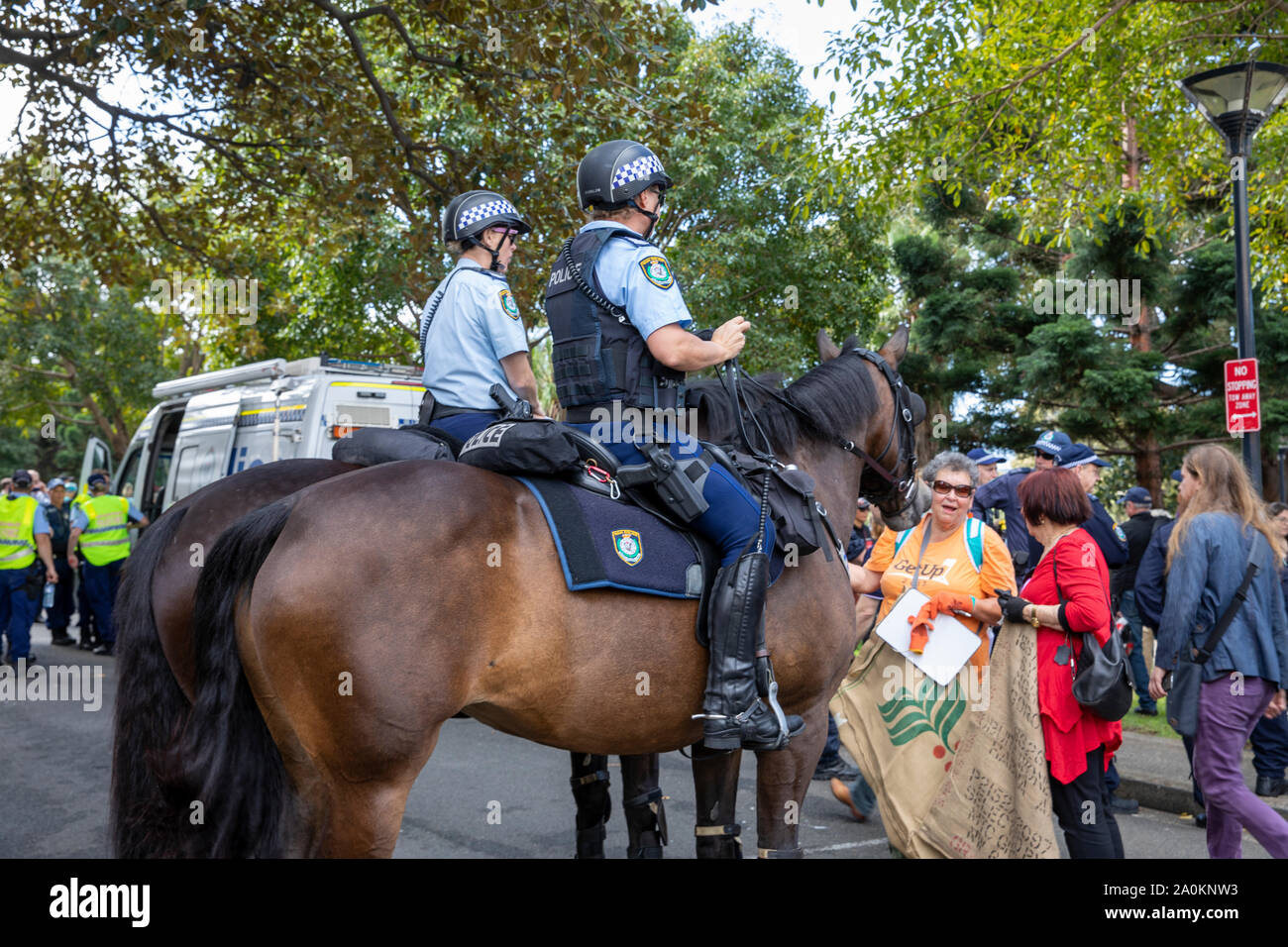 Sydney, female police officers on horses provide crowd control at the Sydney climate change strike rally in Sydney city centre,Australia Stock Photo