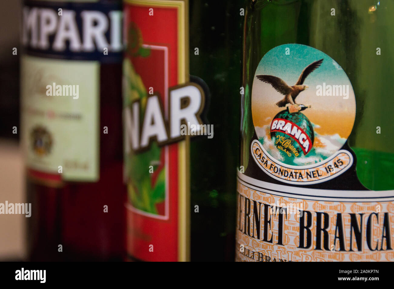 Horizontal close up view of Fernet Branca, Cynar and Campari apperitive bottles in a row. Drinks prepared with these brands are part of argentina food Stock Photo