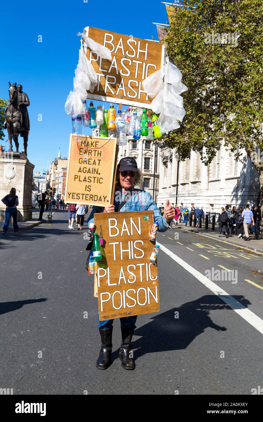 20 September 2019, London, UK - Man with signs calling to ban plastic at the Global Climate Strike in Westminster Stock Photo