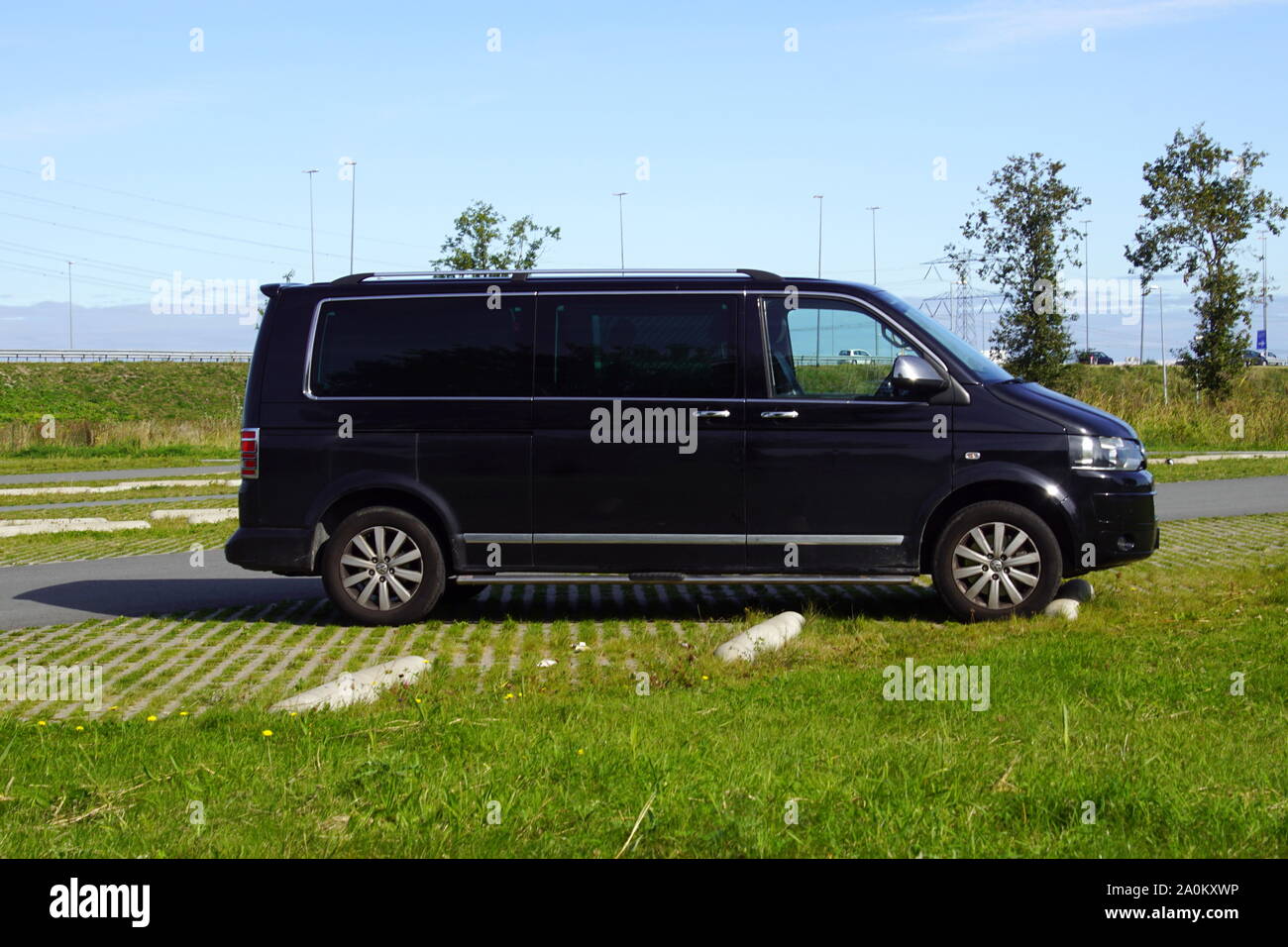 Almere, the Netherland - September 20, 2019: Black Volkswagen Transporter surveillance / private detective van with blinded windows. Stock Photo